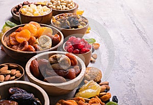 Dried fruits and nuts mix in a wooden bowl. Assortment of candied fruits. Judaic holiday Tu Bishvat. Copy space