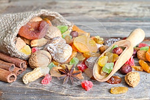 Dried fruits and nuts organic healthy snacks on old planks