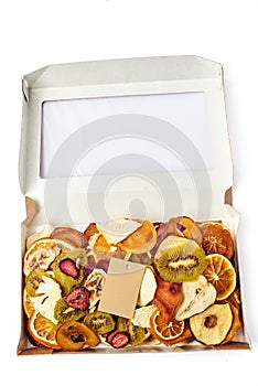 Dried fruits in open craft paper box with transparent lid