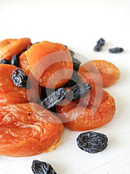 Dried fruits raisins and dried apricots on a white background