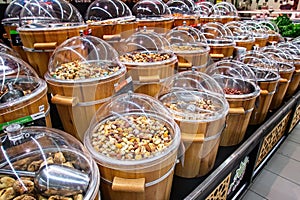 Dried fruits for sale on the market in wooden buckets with lids.