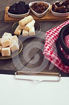 Dried fruits, Turkish delight, lokum and Arab headscarves on the wooden table.