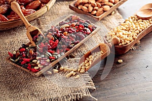 Dried fruits  various nuts  berries  and seeds on a wooden table