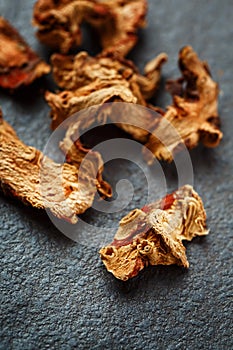 Dried Galangal Root in Close Up on Dark Stone