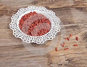 Dried goji berries in white bowl