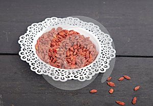 Dried goji berries in white bowl