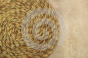 Dried Grass Straw Circular Woven Matt on Vintage Worn Background