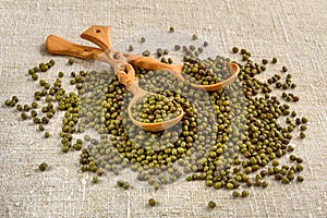 Dried green azuki beans with wooden spoons