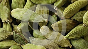 Dried green cardamom pods close up full frame as background