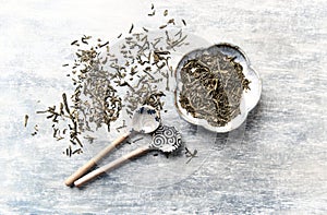 Dried Green Tea Leaves on Bright Background. Top view.