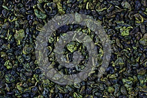 Dried green tea leaves texture close up top view