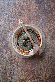 Dried Green Tea  sencha Leaves on rustic stone Background