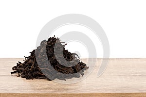 Dried green tea on wood table isolated white background with clipping path