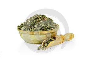 Dried ground mint leaves in a wooden cup with a spoon for spices isolated on a white background. Collection of spices