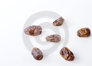 Dried halawi dates on a white