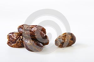 Dried halawi dates on a white