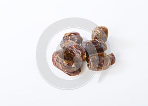 Dried halawi dates on a white