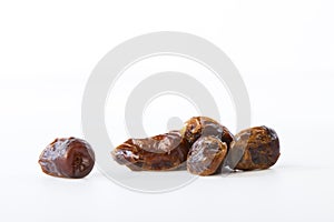 Dried halawi dates on a white