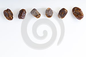 Dried halawi dates on a white