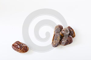 Dried halawi dates on a white
