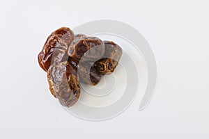 Dried halawi dates on a white