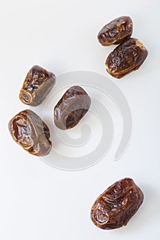 Dried halawi dates on a white