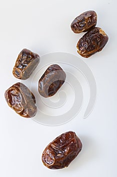 Dried halawi dates on a white