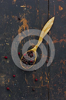 Dried hawthorn berries in a wooden spoon