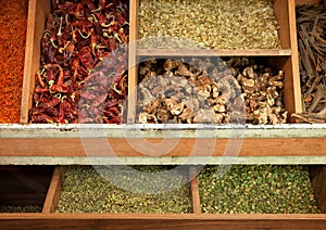 Dried Herbs and Spices in Traditional Wooden Display in an Iranian Bazaar