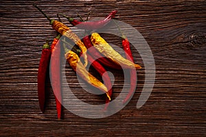Dried hot chili peppers on aged wood photo