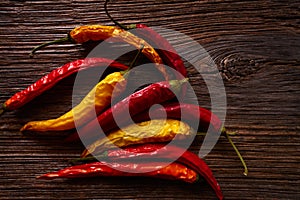 Dried hot chili peppers on aged wood photo