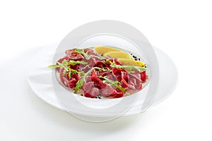 Dried Italian Beef Bresaola with Lemon and Greens Isolated