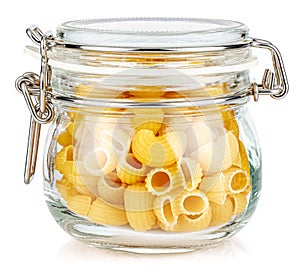 Dried italian pasta snail Pipe rigate in a closed transparent glass jar with rubber seal and metal clamp on lid isolated on white