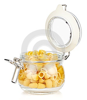 Dried italian pasta snail Pipe rigate in a open transparent glass jar with rubber seal and metal clamp on lid isolated on white