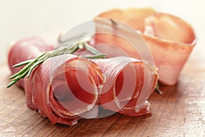 Dried jamon slices on wood table, spanish food