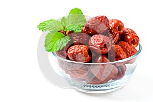 Dried Jujube, Chinese dried red date fruit with Mint leaves in glass cup isolated on white,herbal fruits