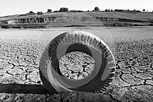 Dried land with cracks and tyre
