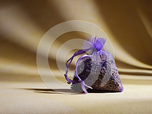 Dried lavender herbs for for relaxing sleep on yellow background