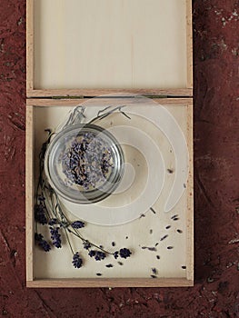 Dried lavender and lavender flowers in a bright wooden box
