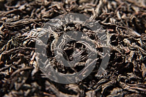 Dried leaves of black tea background.