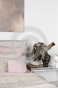 Dried leaves in black vase on bedside table