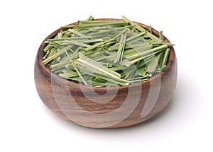 Dried lemongrass herb in wooden bowl