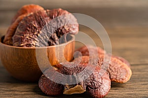 Dried lingzhi mushroom isolated on wooden background