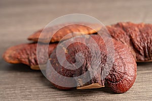 Dried lingzhi mushroom on wooden background, healthy herb food