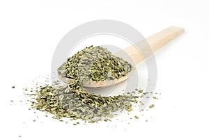 dried lovage herb in wooden spoon isolated on white background. spices and food ingredients. spices and food ingredients