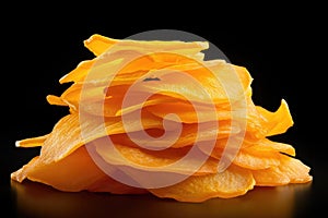 Dried mango slices on black background