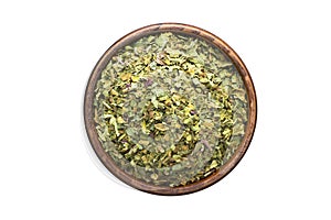 Dried marjoram spice in wooden bowl, isolated on white background. Seasoning top view