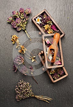 Dried medicinal herbs in wooden boxes for herbal healing tea,