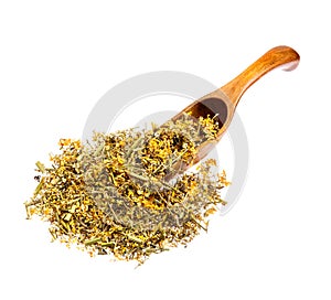 Dried Melilotus officinalis Yellow Sweet Clower on the wooden spoon isolated.