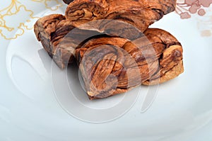 Dried melon in the form of plait on cut melons isolated on white background